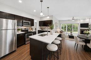 Canandaigua townhouse for rent - A modern kitchen with dark wood cabinets and stainless steel appliances.