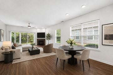 Canandaigua townhouse for rent - A modern living room with a fireplace and a dining table set up.