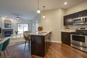 Canandaigua townhouse for rent - A modern kitchen with dark wood cabinets and stainless steel appliances.
