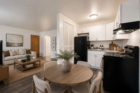 Penfield apartment for rent - A modern kitchen with a black refrigerator and white cabinets.