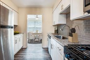 Painted Post apartment for rent - kitchen with white cabinets, granite counters, and stainless appliances