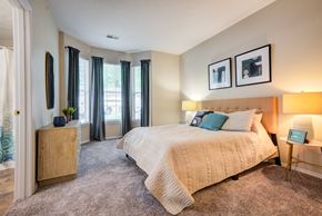 Coraopolis apartment for rent - a bedroom with a large bed and a window