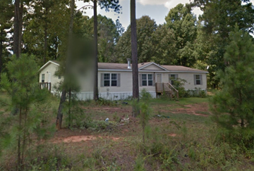 Greenwood house for rent - a house in the woods with a yard and trees