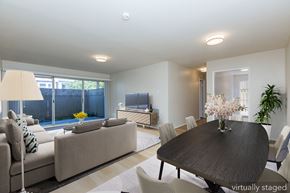 Oakland apartment for rent - A modern living room with a large couch and a television.