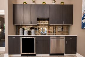 Lenexa townhouse for rent - a kitchen with gray cabinets and stainless steel appliances