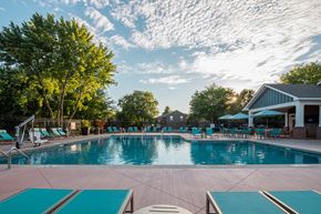 Lenexa townhouse for rent - a swimming pool with lounge chairs and umbrellas