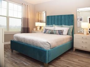 Dayton apartment for rent - a bedroom with a bed with a blue headboard and pillows