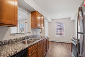 Grand Rapids apartment for rent - A kitchen with wooden cabinets and a granite countertop.