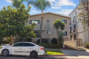 Los Angeles apartment for rent - A car with Beach Front Property Management written on it is parked in front of a house.