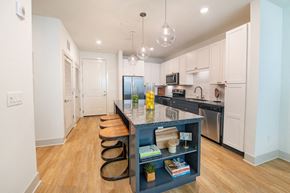 Jacksonville apartment for rent - a kitchen with a large island with stools