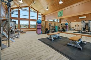 Mill Valley apartment for rent - a gym with weights and cardio equipment and a large window