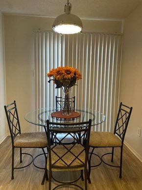 New Braunfels apartment for rent - a dining room table with three chairs and a vase of flowers