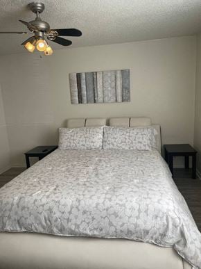 New Braunfels apartment for rent - a bedroom with a bed and a ceiling fan