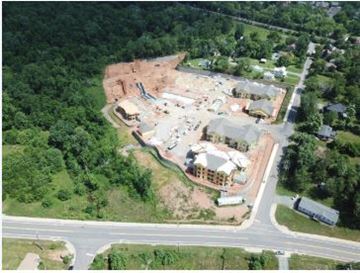 Crozet apartment for rent - An aerial view of a construction site surrounded by trees and a road.
