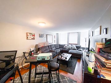 Chicago apartment for rent - A living room with a grey couch and a black coffee table.