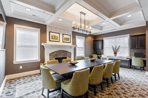 Victor apartment for rent - a dining room with a table and chairs and a fireplace