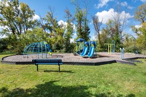 Victor apartment for rent - a playground with slides and a bench in a park