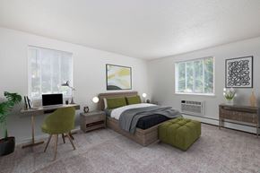 Fairport apartment for rent - a bedroom with a bed and a desk with a computer