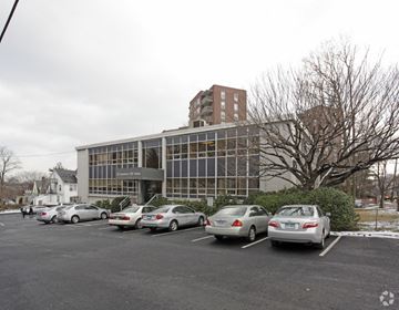 Stamford apartment for rent - a parking lot full of cars in front of a building