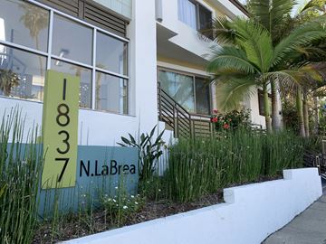 Los Angeles apartment for rent - the facade of a building with a sign in front of it