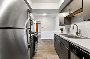Jenison apartment for rent - an empty kitchen with stainless steel appliances and a sink
