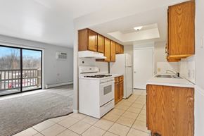 Jenison apartment for rent - a kitchen with white appliances and wooden cabinets and a window