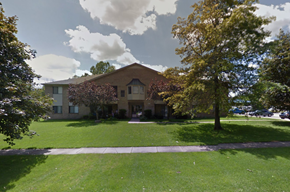 Shelby Twp apartment for rent - the front of a house with a lawn and trees