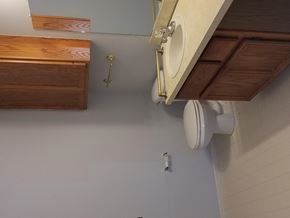 Shelby Twp apartment for rent - a bathroom with a toilet and wooden cabinets