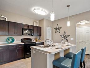 Sherman apartment for rent - A kitchen with a table and chairs set for two.