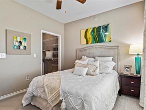 Sherman apartment for rent - A bedroom with a large bed and a ceiling fan.