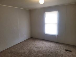 Shawnee house for rent - A room with a carpeted floor and a window letting in sunlight.