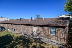 Vandalia apartment for rent - the front of a brick building with a driveway and grass