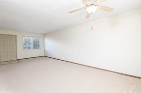 Vandalia apartment for rent - the living room of an empty house with a ceiling fan