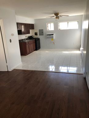 Paterson apartment for rent - A kitchen with dark wood floors and white walls.