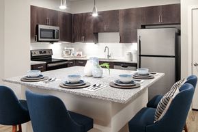 San Antonio apartment for rent - A modern kitchen with a dining table set for two.