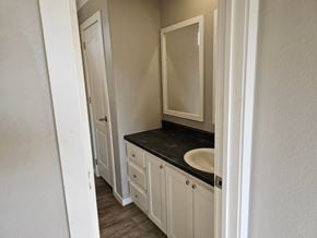 Shawnee house for rent - A bathroom with a sink and mirror.