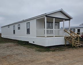 Shawnee house for rent - A white mobile home with a porch and a covered patio.