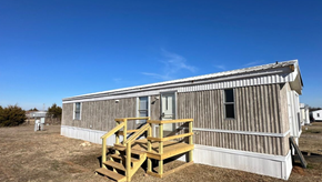 Shawnee house for rent - A house made of wood and metal with a wooden staircase.