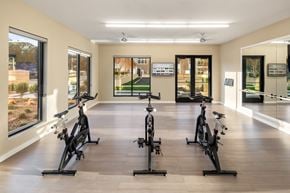 Glen Cove apartment for rent - a gym with exercise bikes and windows on the wall