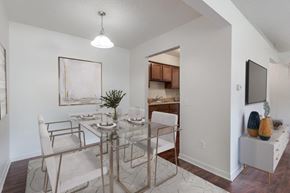 Webster apartment for rent - a dining room with a glass table and chairs