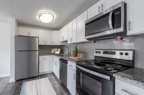 Webster apartment for rent - a kitchen with stainless steel appliances and white cabinets