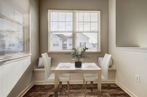 Webster apartment for rent - a dining room with a table and chairs and two windows