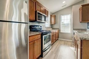 Webster apartment for rent - a kitchen with stainless steel appliances and wooden cabinets