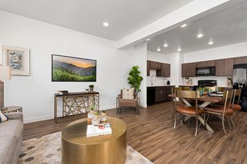 Herriman townhouse for rent - A modern living room with a wooden floor and a large painting on the wall.