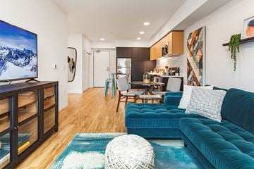 Portland apartment for rent - a living room with a blue couch and a tv