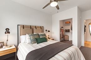Portland apartment for rent - a bedroom with a large bed and a ceiling fan