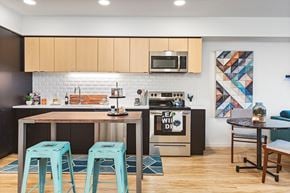 Portland apartment for rent - a kitchen and dining area with blue stools and a counter