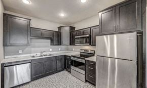 Annandale apartment for rent - a kitchen with stainless steel appliances and black cabinets