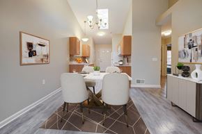Farmington apartment for rent - A dining room with a table set for two and a chandelier hanging from the ceiling.