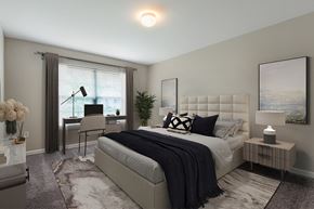 Webster apartment for rent - A bedroom with a large bed and a window with curtains.